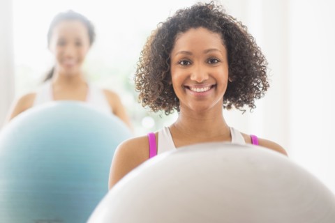Women working out with fitness balls in exercise class