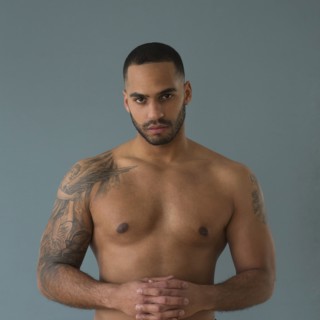 Shirtless Hispanic man with tattoos