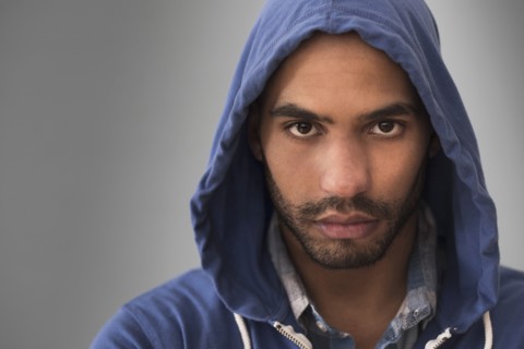 Serious Hispanic man wearing hoodie