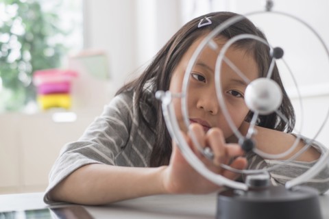 Chinese student examining molecular model