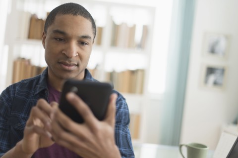 Black man using digital tablet