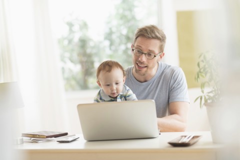 Caucasian father and baby using laptop