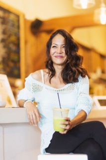 Chinese woman drinking smoothie in cafe