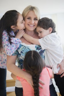 Close up of Caucasian mother and children hugging