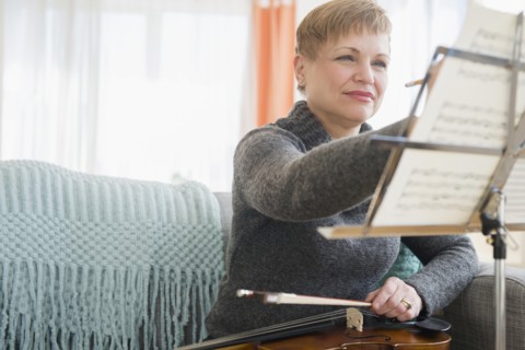 Caucasian violinist writing on sheet music