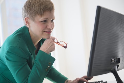 Caucasian businesswoman working at computer
