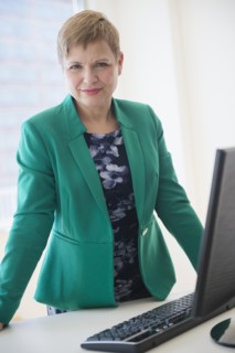 Caucasian businesswoman standing at computer
