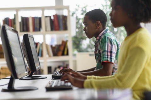 Black students using computers in classroom