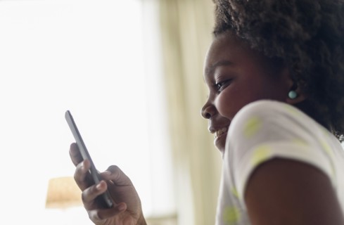 Close up of Black girl using cell phone