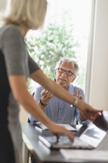 Older Caucasian business people arguing in office meeting