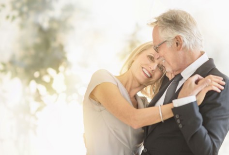 Smiling older Caucasian couple dancing