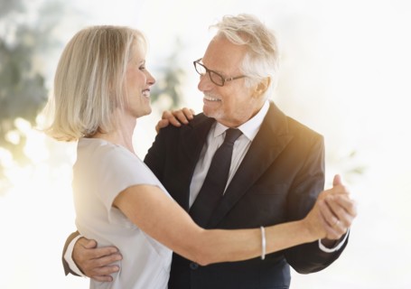 Smiling older Caucasian couple dancing