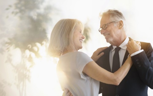 Smiling older Caucasian couple dancing