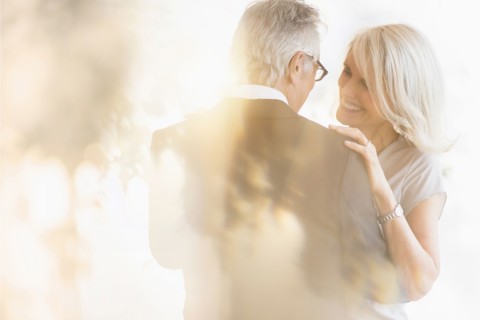 Smiling older Caucasian couple dancing