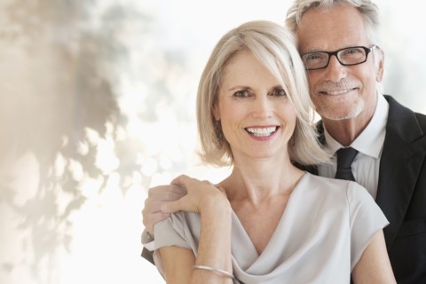 Smiling older Caucasian couple hugging