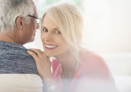 Close up of older Caucasian couple whispering