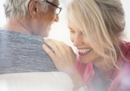 Close up of older Caucasian couple whispering