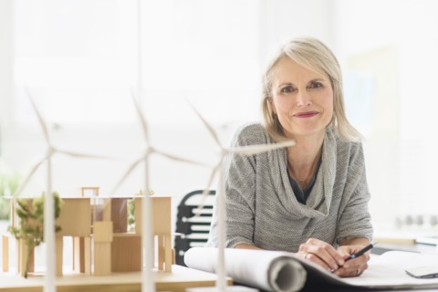 Older Caucasian architect sitting in office