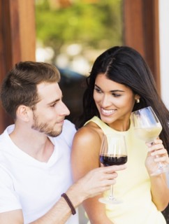 Hispanic couple drinking wine