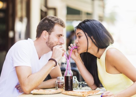 Hispanic couple drinking soda at cafe