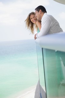 Couple hugging on balcony over ocean