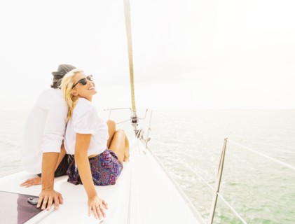 Couple cuddling on deck of sailboat