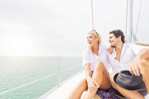 Couple hugging on deck of sailboat