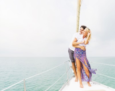 Couple hugging on deck of sailboat
