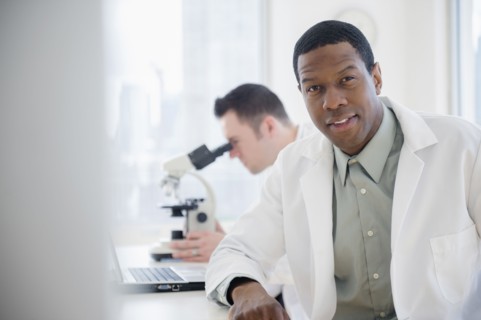 Scientist sitting at table in lab