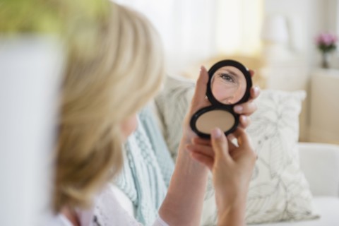 Caucasian woman admiring herself in mirror
