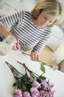 Caucasian woman trimming flowers