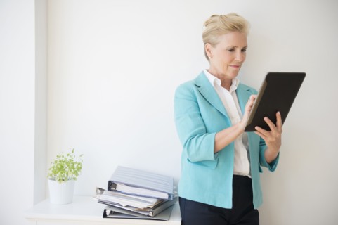 Caucasian businesswoman using digital tablet in office