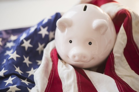 Close up of piggy bank and American flag