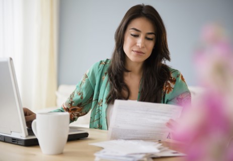 Woman paying bills on laptop