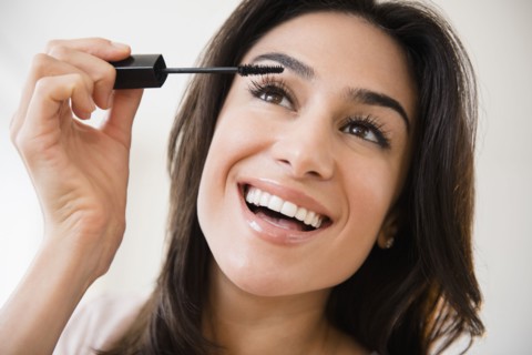 Close up of woman applying makeup