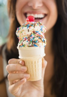 Close up of woman holding ice cream cone