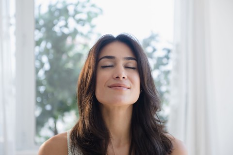 Calm woman breathing with eyes closed