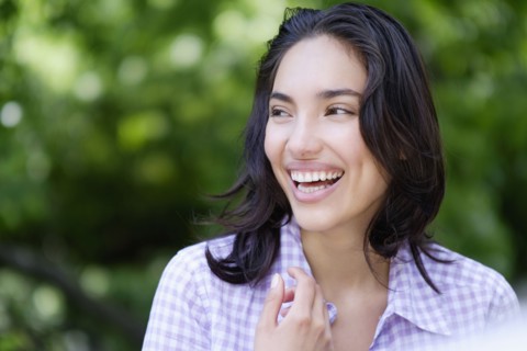 Hispanic woman laughing outdoors