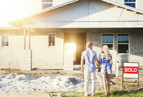 Caucasian couple admiring new home