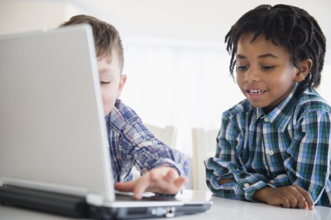 Close up of boys using laptop at desk