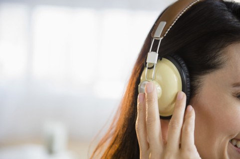 Mixed race woman listening to headphones