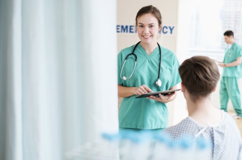 Doctor talking to patient in hospital emergency room