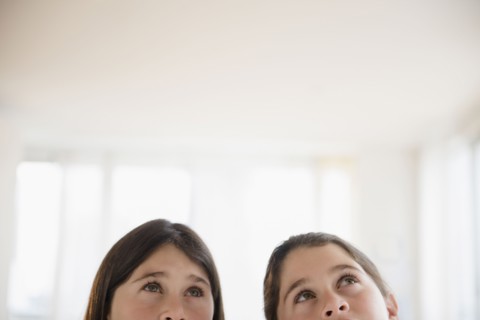 Caucasian twin sisters thinking