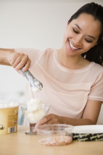 Chinese woman scooping ice cream
