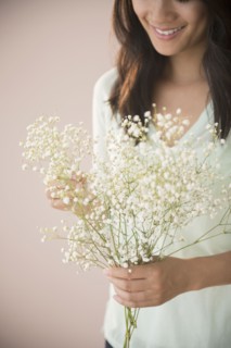 Chinese woman holding bunch of flowers
