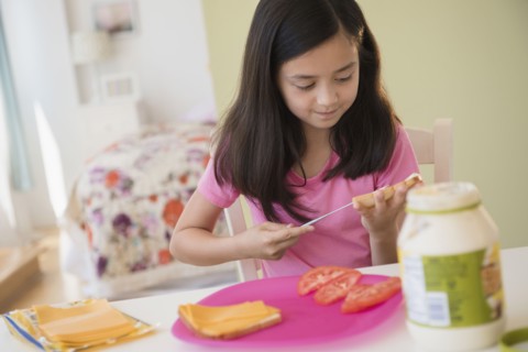 Girl making lunch sandwiches