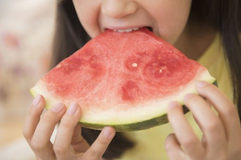 Close up of girl eating watermelon