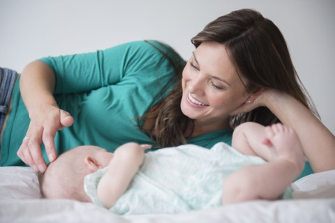 Mother playing with baby daughter