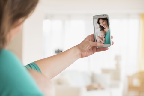 Mother taking selfie with baby daughter