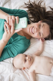 Mother taking selfie with baby daughter